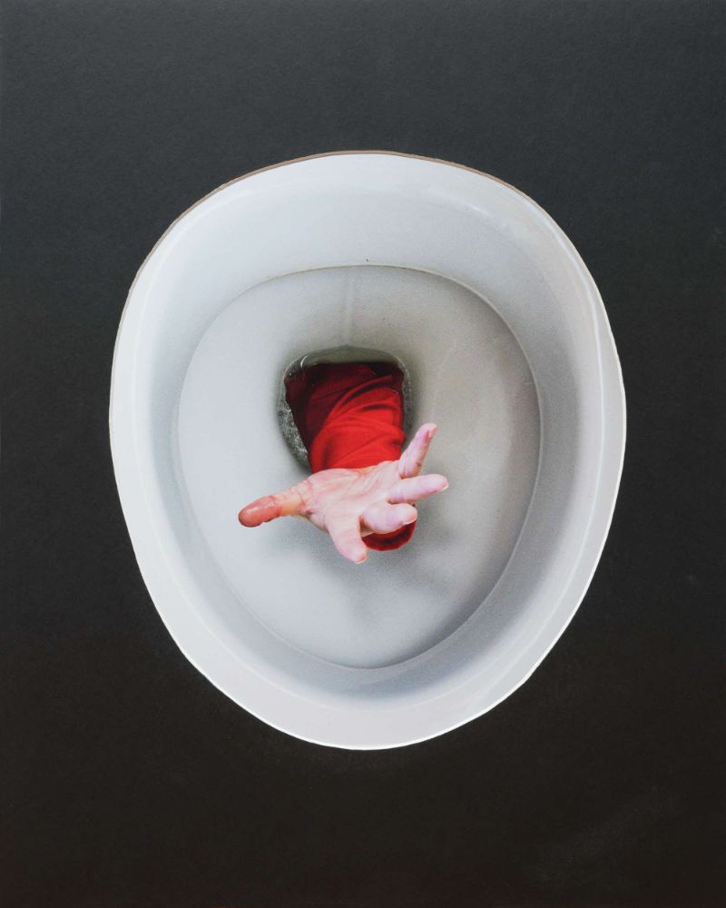 This is a blend of two shots: a straight shot of a toilet, and my arm in the bathroom sink with the tripod sticking out the top window